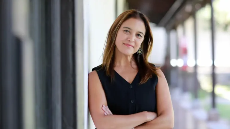Mujer reflexionando frente a una pantalla luminosa